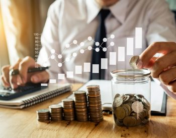 businessman holding coins putting in glass with using smartphone and calculator to calculate  concept saving money for finance accounting